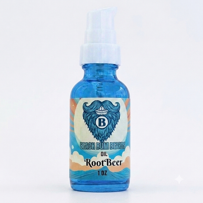 A 1 oz glass bottle of Beach Bum Beards Root Beer Oil, featuring a blue translucent bottle, white pump dispenser, and a colorful label with a blue bearded man's profile and the text 'Beach Bum Beards Oil Root Beer 1 OZ'.